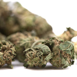 Dried cola full-term thca smalls flower cannabis buds with green and brown hues covered in fine trichomes for creamy strawberry cheesecake fans