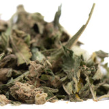 A pile of dried cola full-term thca trim cannabis buds with green leaves and brownish trichomes for strawberry cheesecake full-term use