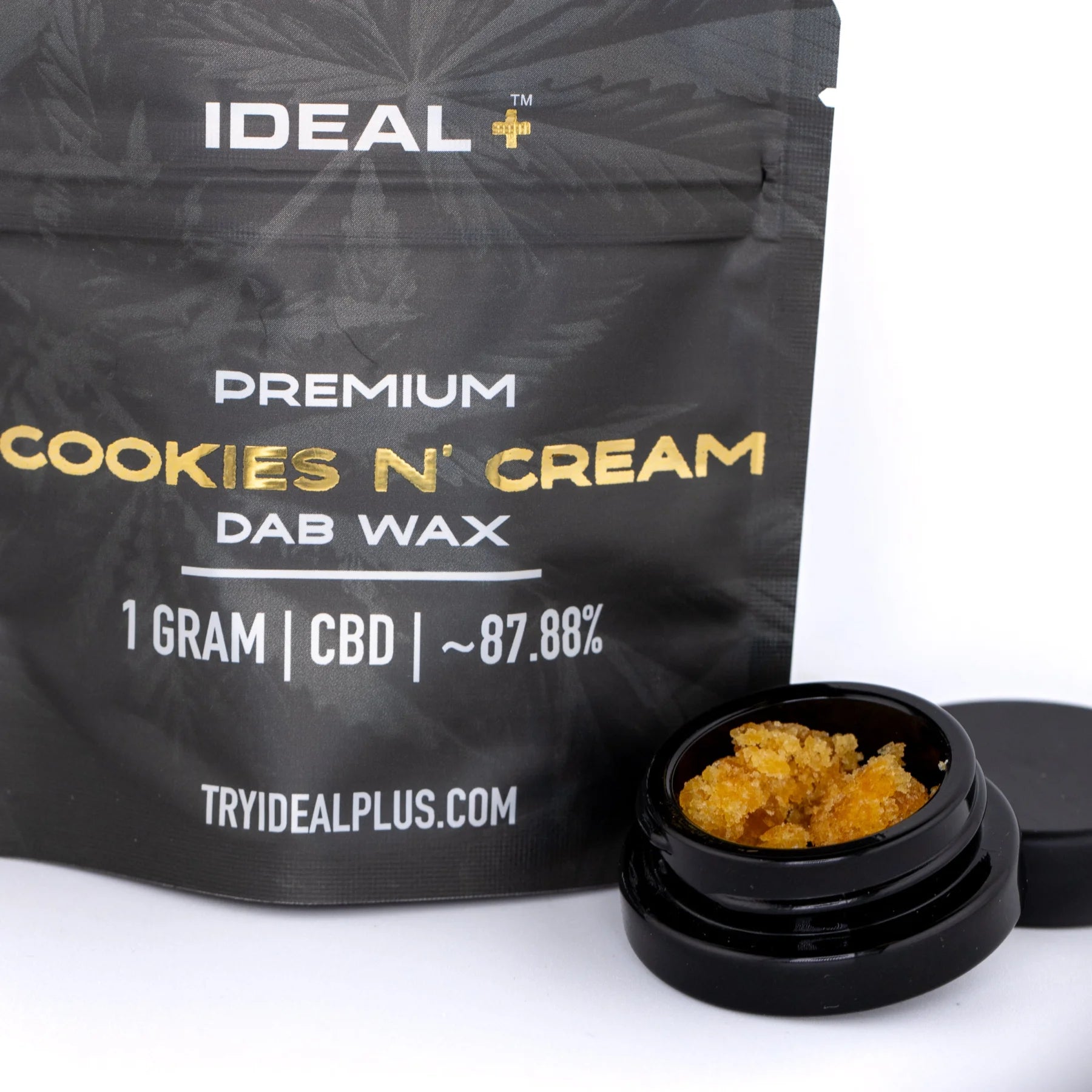 Black pouch of ideal plus premium cookies and cream cbd dab wax with 1 gram amber dab wax in black jar