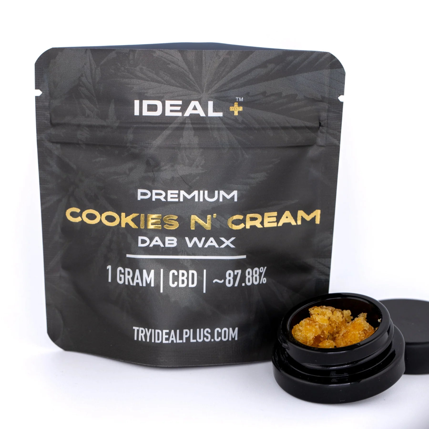 Black pouch of ideal plus premium cookies and cream 1 gram cbd dab wax with golden text and amber concentrate jar