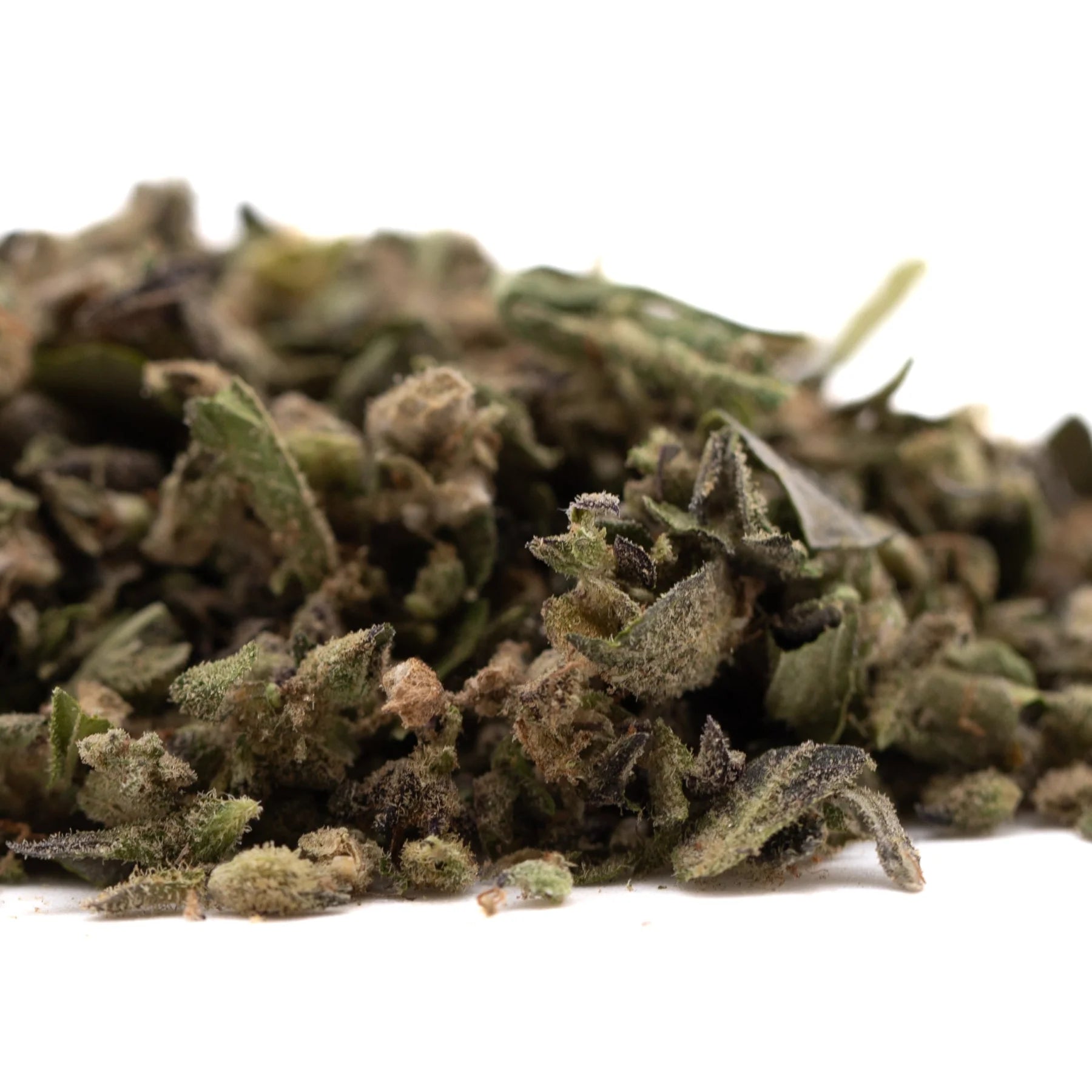 A pile of cream caramel full-term thca trim hemp flower buds with green brown and purple hues