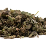 A pile of cream caramel full-term thca trim hemp flower buds with green brown and purple hues