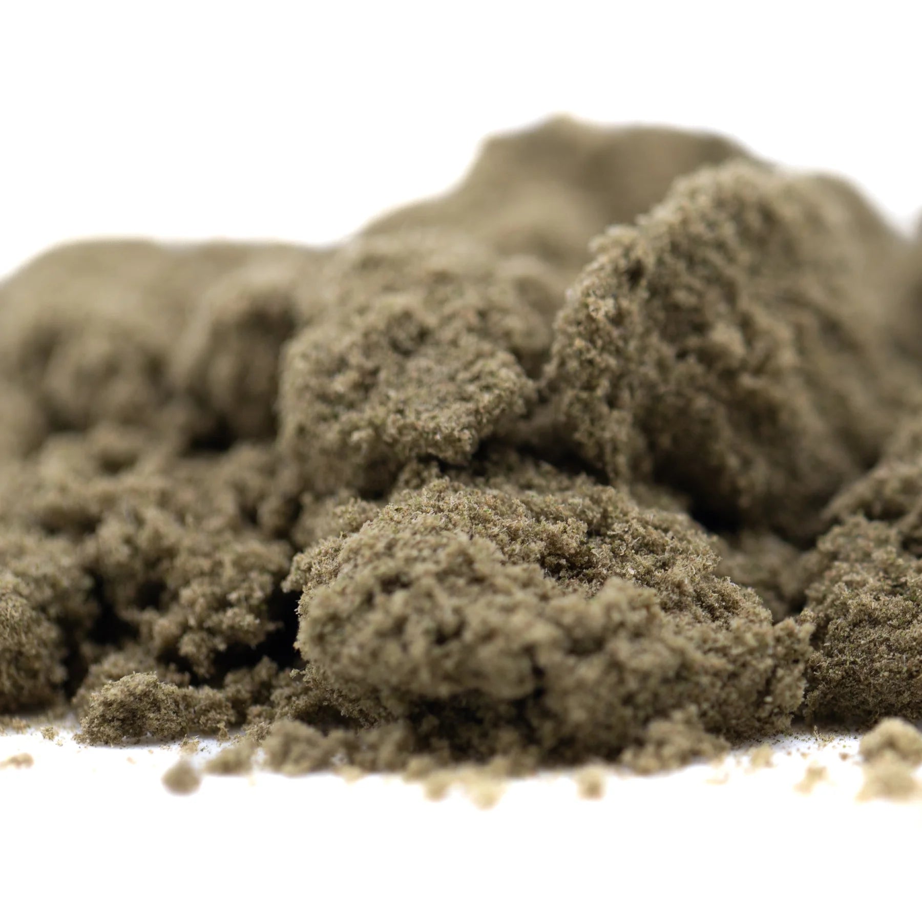 A mound of fine textured cream caramel thca kief in muted olive green from hemp flower product full-term