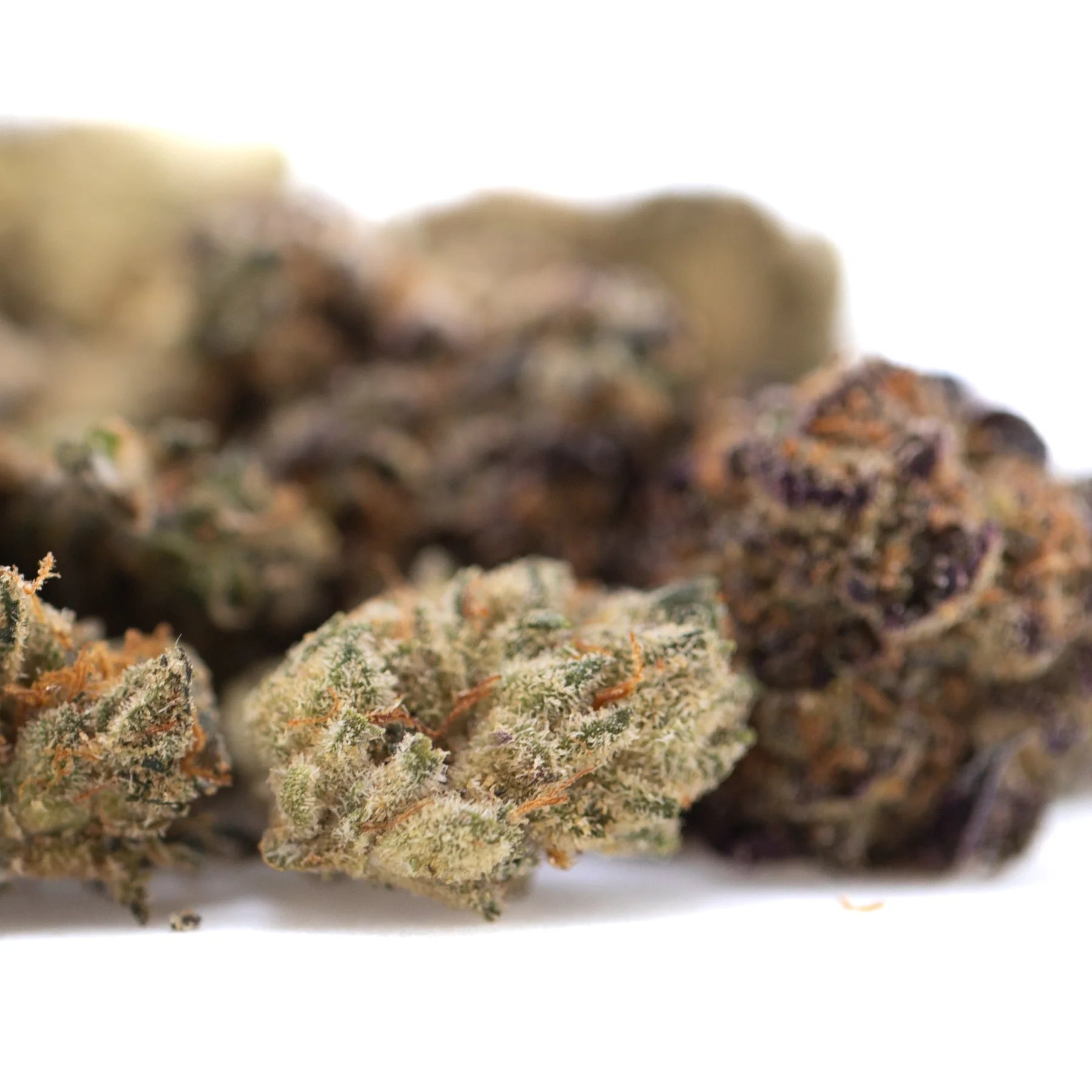 Green and orange-hued critical berries cbd smalls flower with a frosty textured surface smalls hemp flower