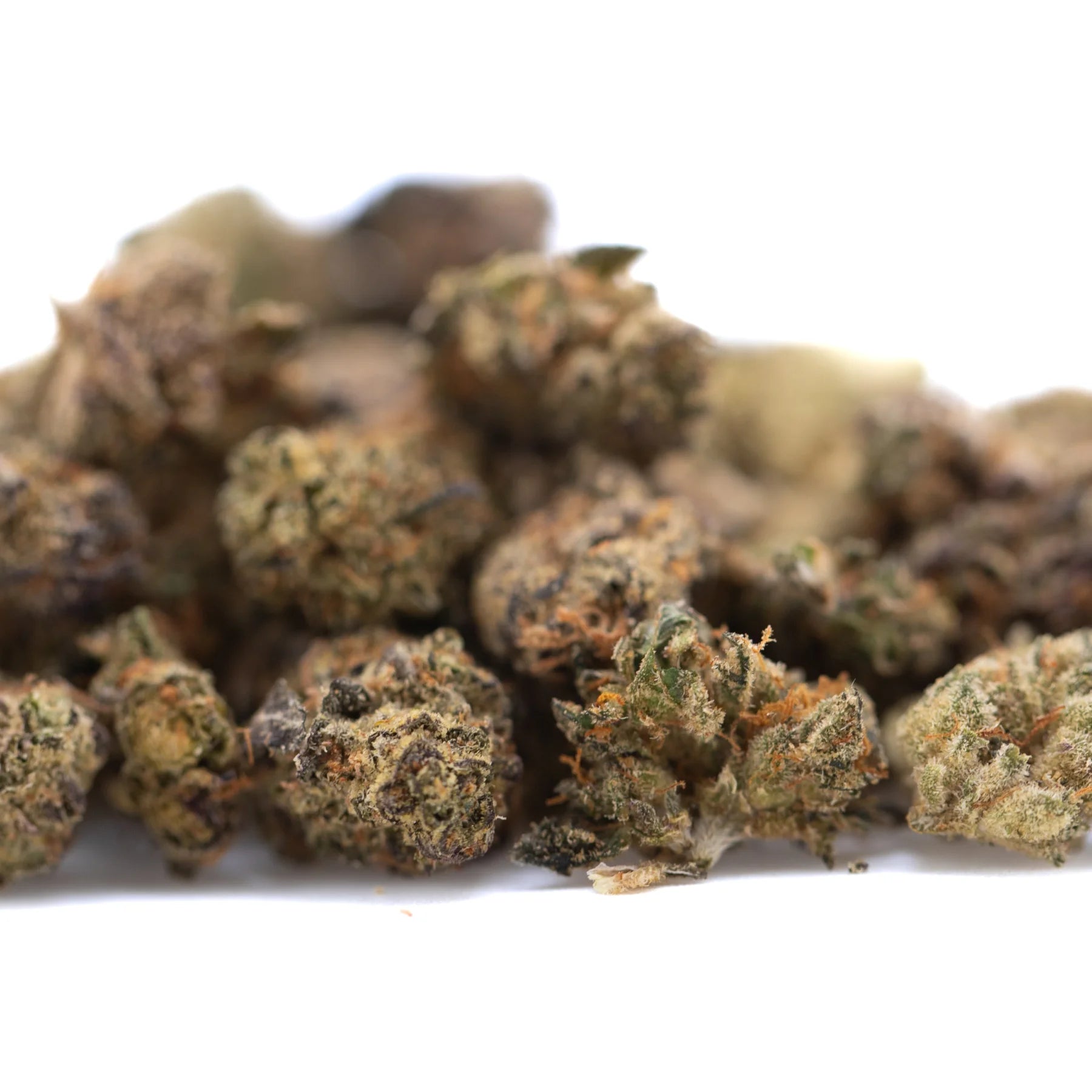 A pile of critical berries cbd smalls flower hemp buds with green brown and orange hues for full-term use