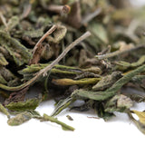 Dried green tea leaves in light and dark shades with yellow hints from daily grape greenhouse thca trim wholesale hemp flower