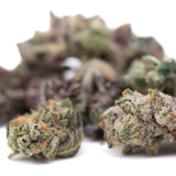 Dark Jokerz indoor THCa flower small with orange hairs and frosty white coating