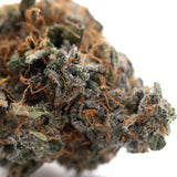 Dense resinous dea-4 indoor thca flower bud with green orange hues and white trichomes for maximum therapeutic depth