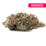 Greenhouse THCa hemp flower bud with white trichomes, purple hues, calming numbness