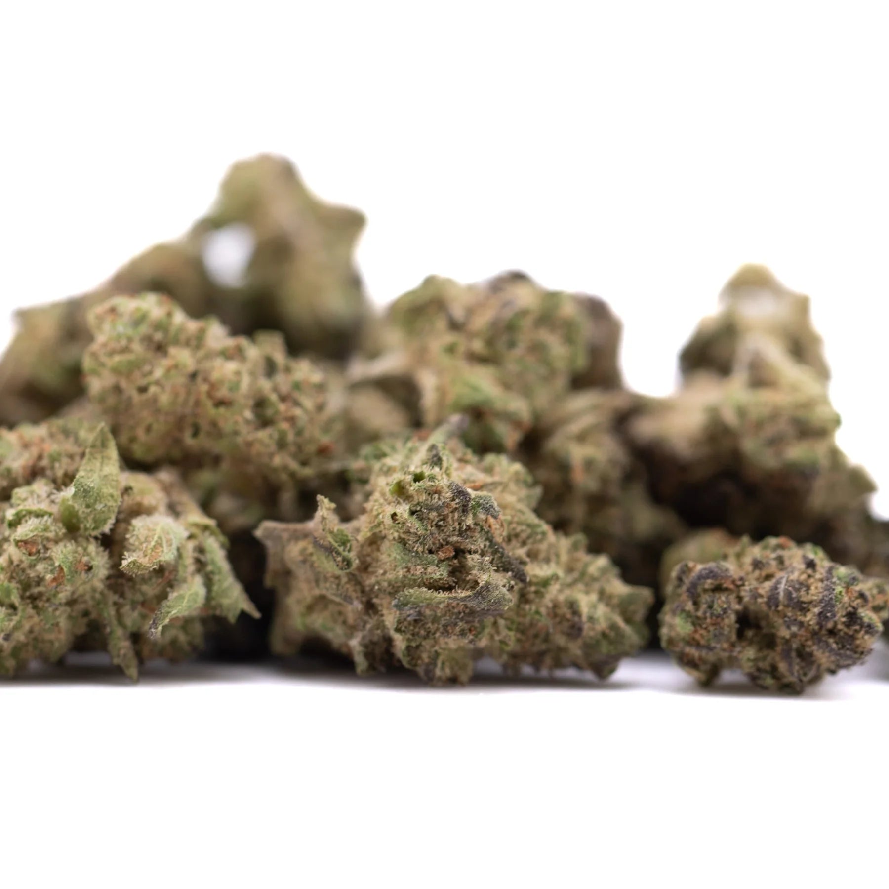 A pile of deep space hemp flower greenhouse smalls with knockout genetics showing green and brown buds covered in trichomes