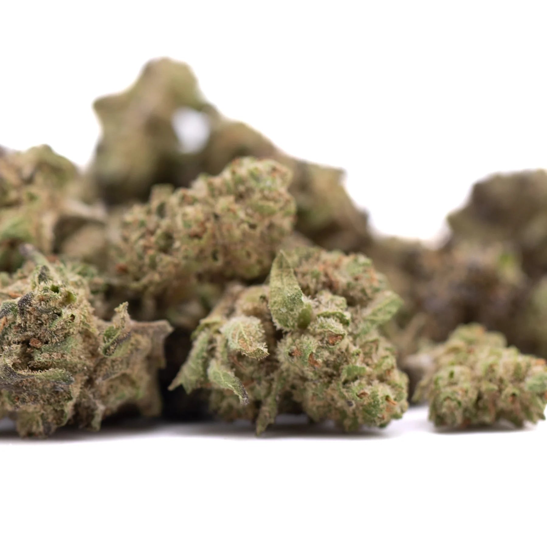 A pile of deep space hemp flower greenhouse smalls with frosty green buds and purple and brown trichomes showcasing knockout genetics