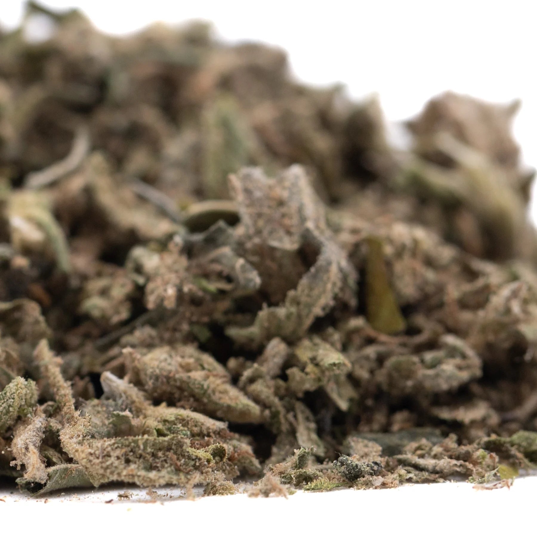 A pile of green brown and gray dried cannabis buds in dirty laundry full-term thca trim showcasing its terpene profile