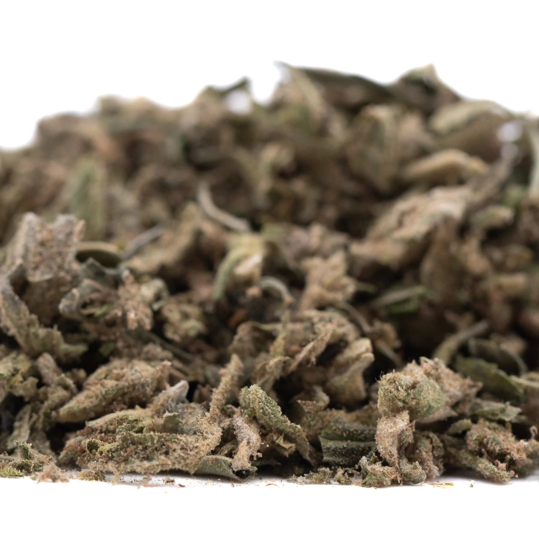 A pile of dried green and brown dirty laundry full-term thca trim buds showcasing the terpene profile