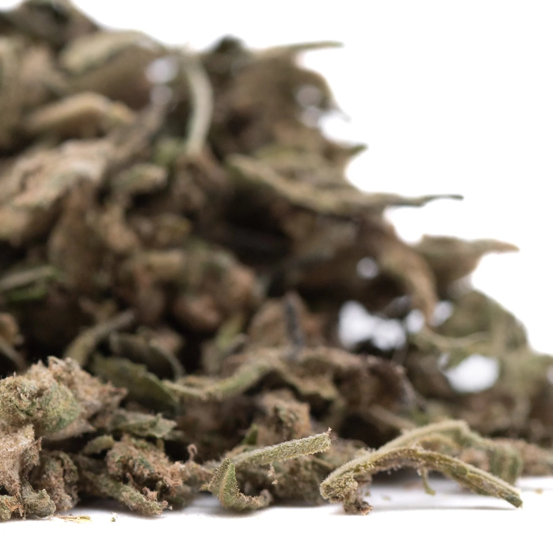 A pile of dried green and brown cannabis buds showing laundry full-term thca trim with rich terpene profile