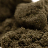 Dark brown textured mossy clumps of durban poison thca kief for living cannabis extraction and use