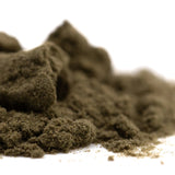 A mound of fine dark olive-green durban poison thca kief with a granular texture for living cannabis use