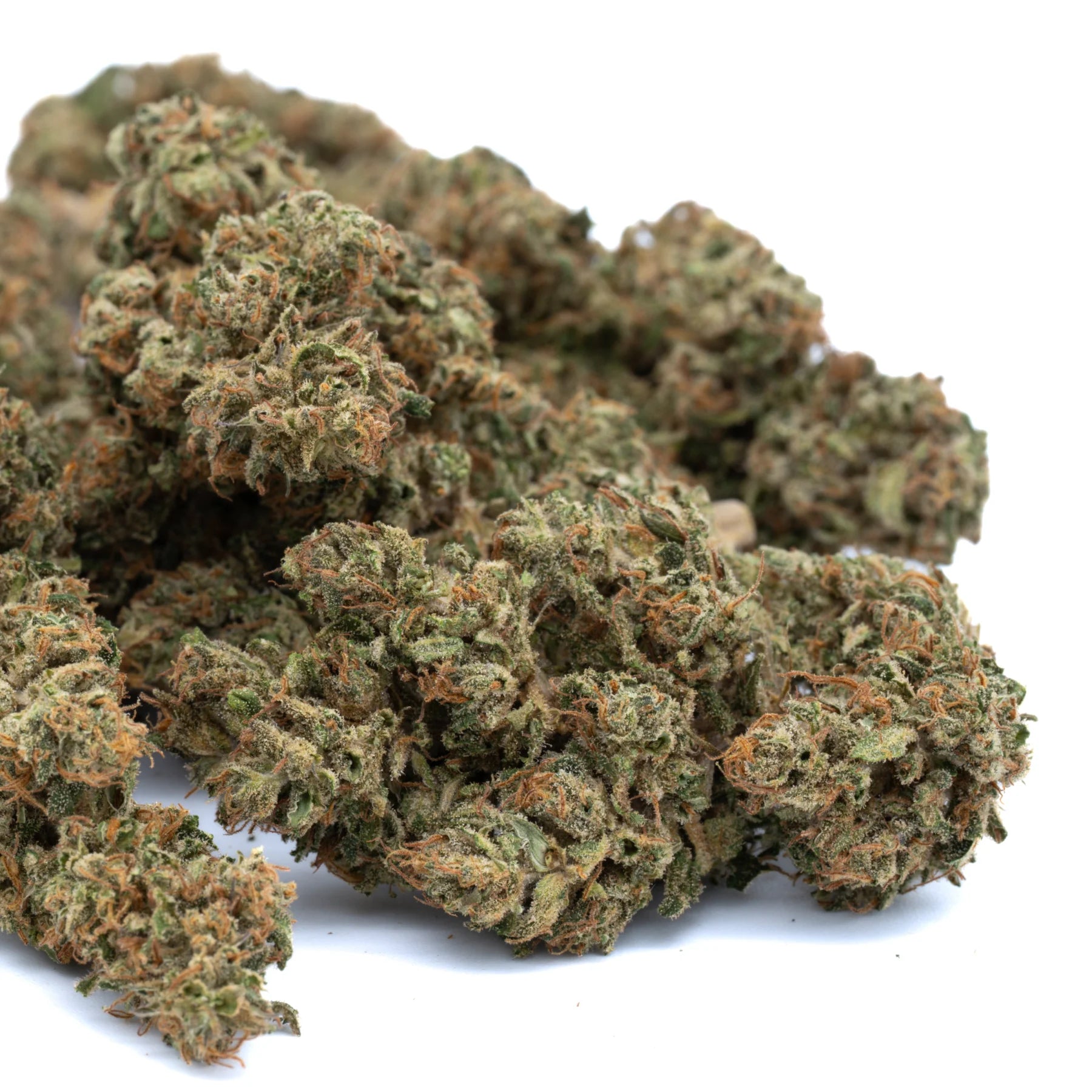 A pile of dense green and orange early blossom full-term cbd hemp buds with frosty texture and high cannabidiol potency
