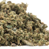 A dense green and brown early blossom full-term cbd trim hemp flower bud with visible trichomes from auto tsunami