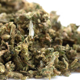 Dense early blossom full-term cbd trim hemp flower bud with green and amber hues covered in fine trichomes