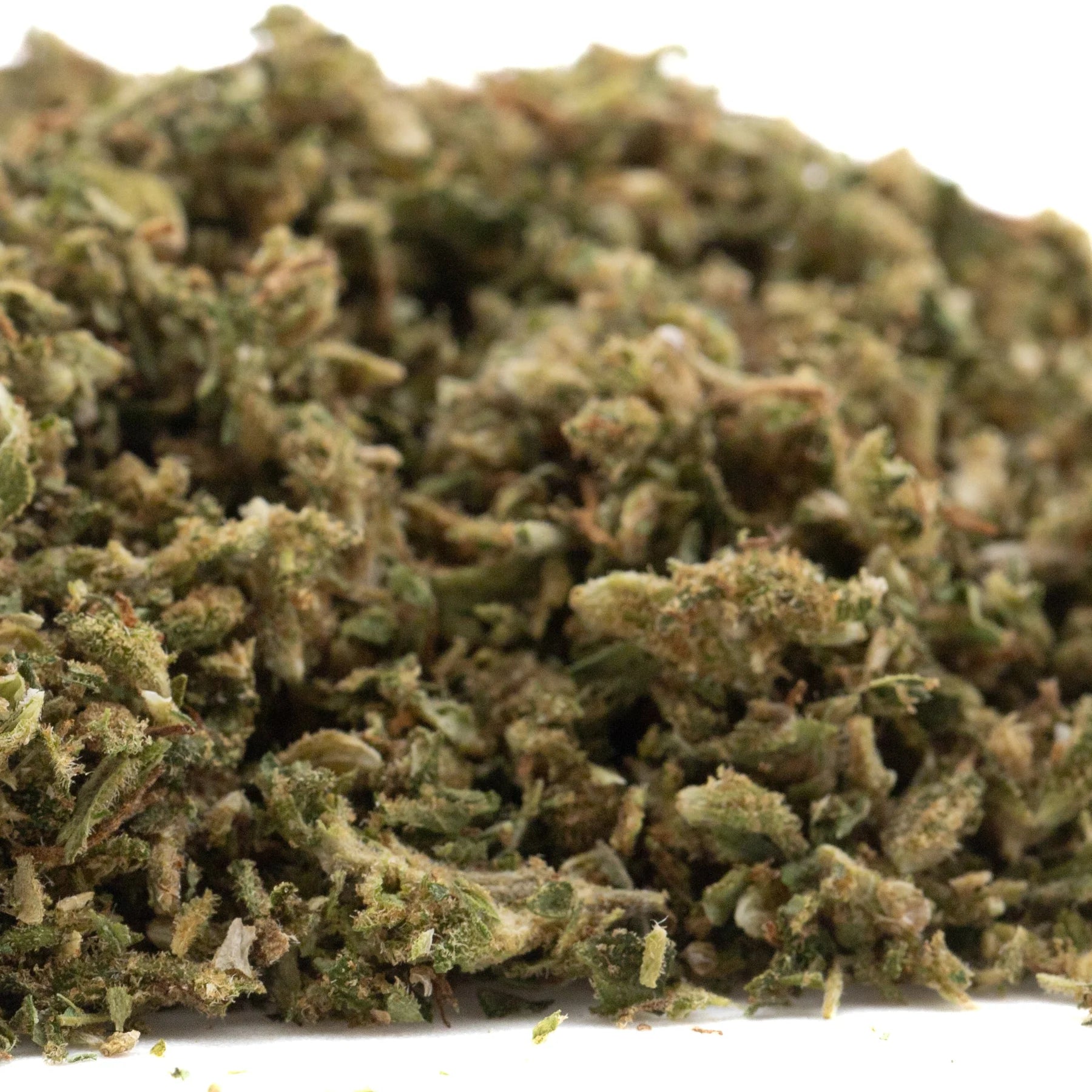 A pile of early cherry full-term dried cbd hemp flower buds in green and brown hues covered in fine trichomes