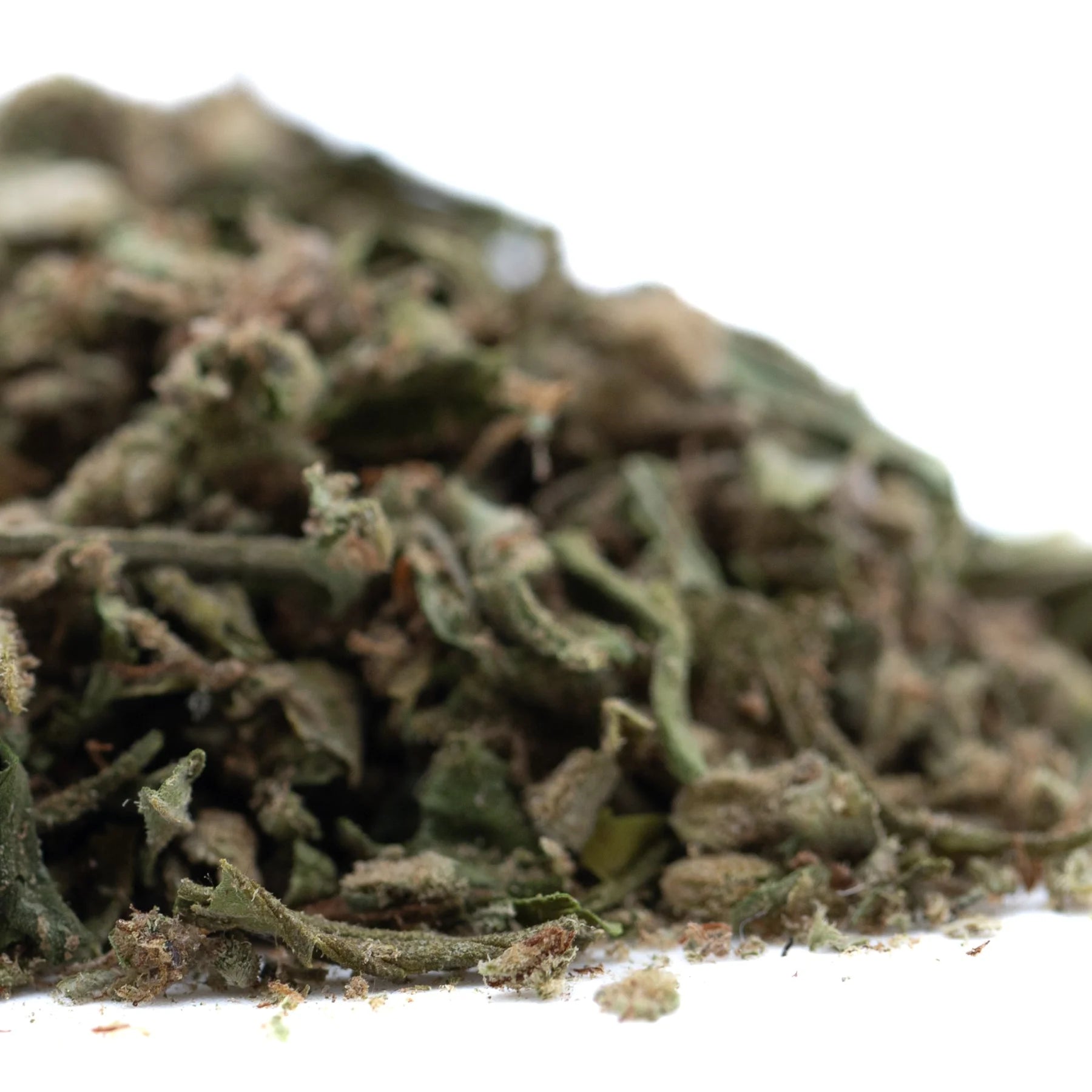 A pile of dried greenish-brown face fat full-term thca trim wholesale hemp flower buds with visible trichomes and leafy texture