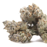 A dense frosty flyin hawaiian indoor thca flower with green gray hues and trichomes, hinting at oregon blueberry