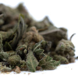 A pile of fog dog trim thca trim hemp flower buds with green and brown hues covered in fine trichomes