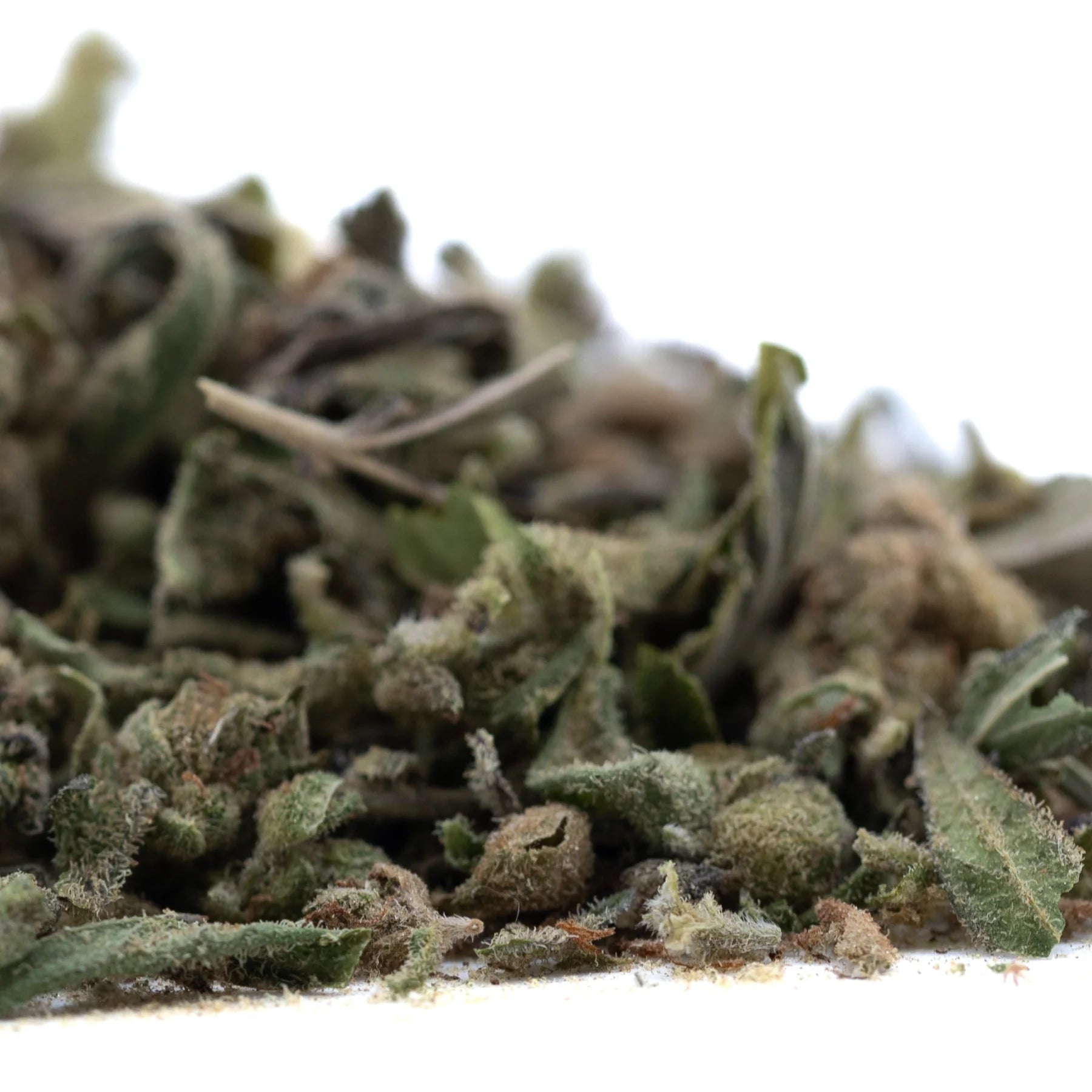 A pile of dried greenish-brown fog dog trim thca trim hemp flower buds with visible trichomes and fuzzy texture