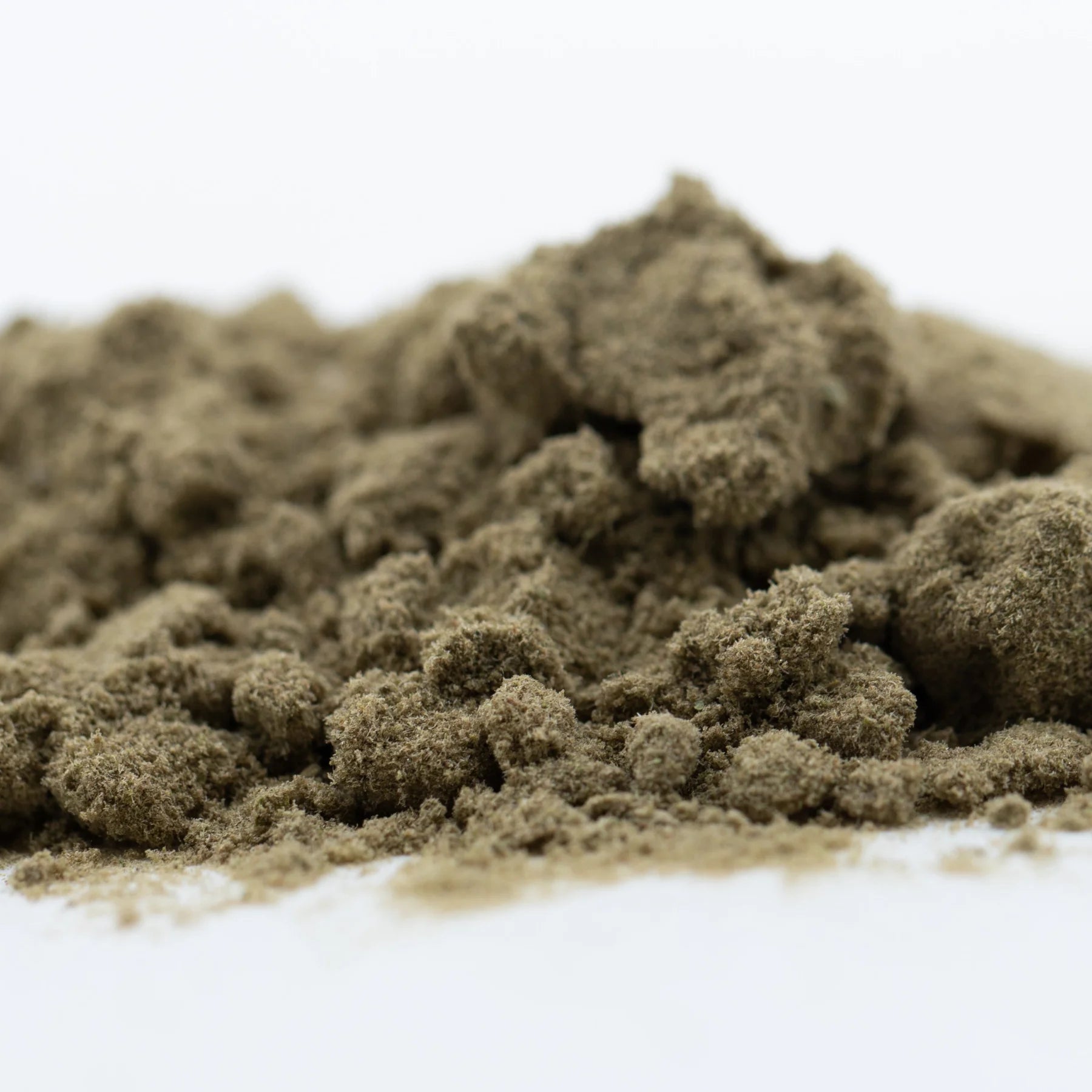 A mound of fine earthy brown fog dog kief showcasing concentrated potency from hemp flower material