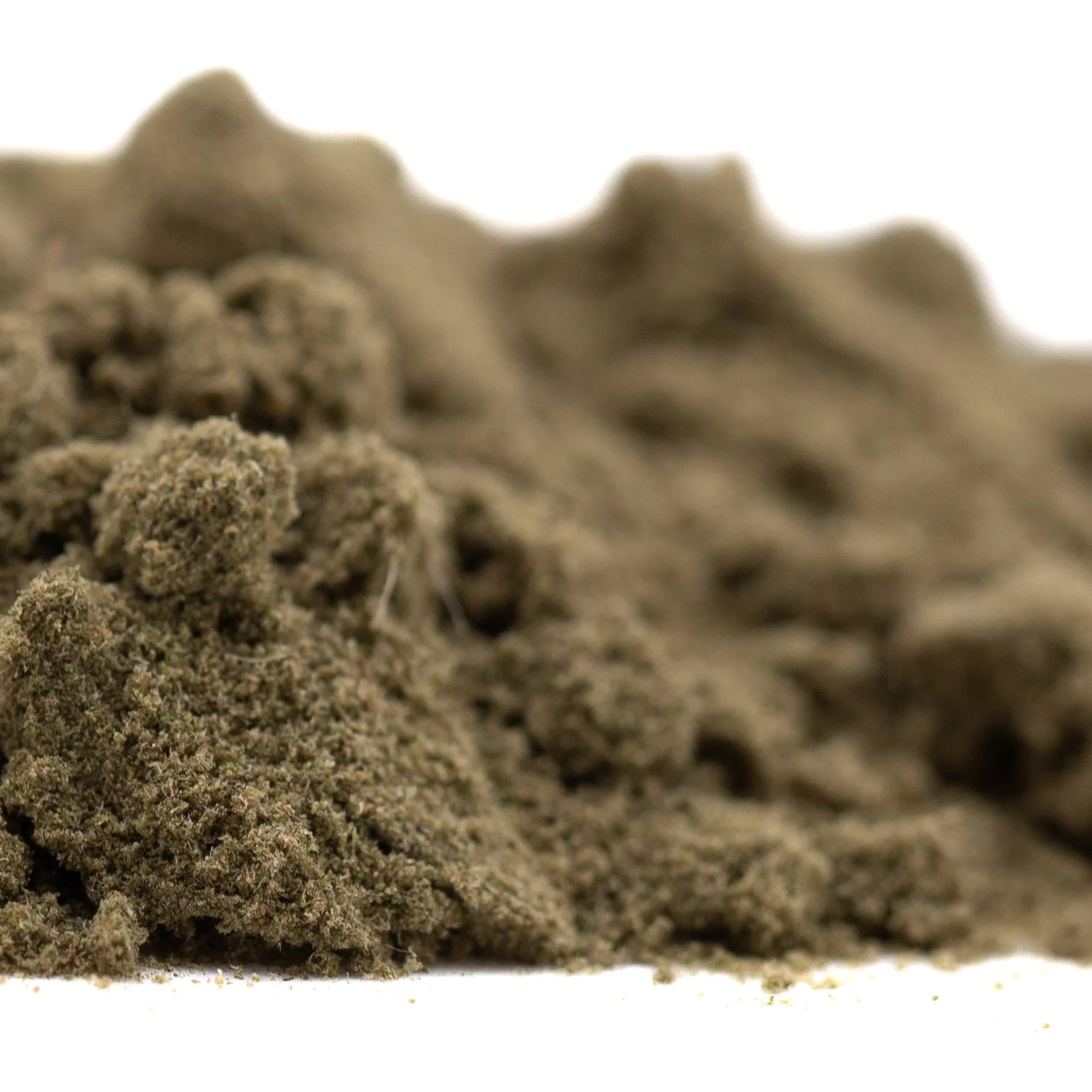 A mound of fine textured olive-green fog dog thca kief for hemp flower with candy x gravenstein offering a floating body high