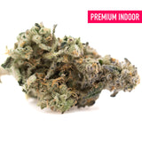 A dense green and white fornicate indoor thca flower bud with frosty texture and earthy gassy funk terpene profile