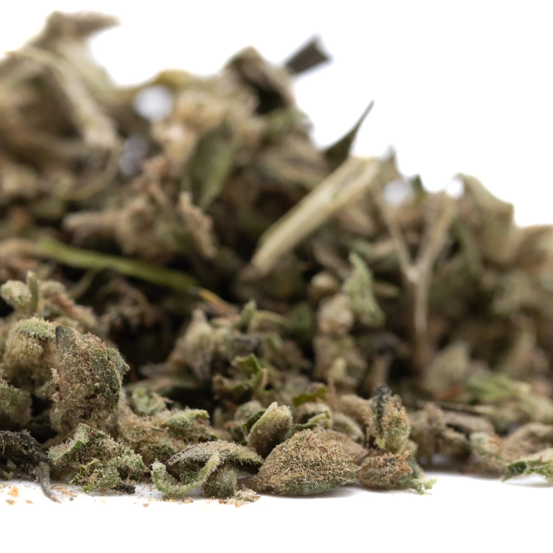 A pile of green brown and gray dried cannabis buds from froot by the foot full-term thca trim for mental clarity use