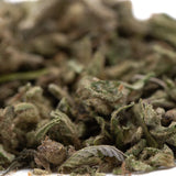 A pile of green and brown foot full-term thca cannabis buds covered in fine trichomes for mental clarity benefits