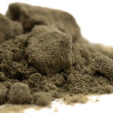 A mound of coarse dark olive-green thca kief with gritty texture for therapeutic mood enhancement in hemp flower use