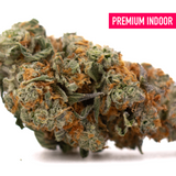 Frosted Flakes Indoor THCa Flower with dense trichome-rich buds and vibrant orange pistils