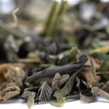 A mix of dried sage leaves in green and brown shades showcasing greenhouse thca kush phenotype trim wholesale quality