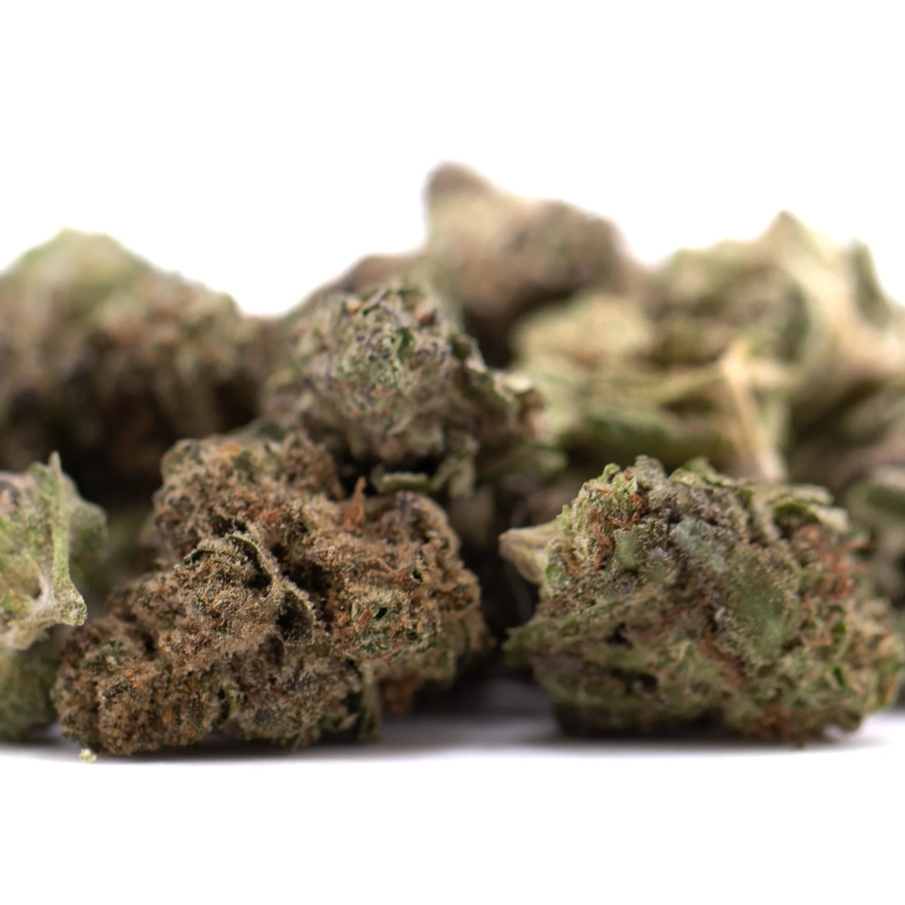 A pile of gas monkey thca greenhouse smalls hemp flower buds with green brown and orange trichomes visible