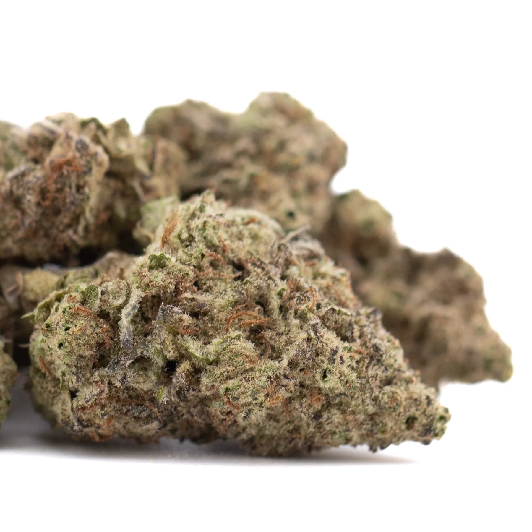 A dense cannabis bud with green and brown hues showcasing greenhouse thca and kush genetics potency