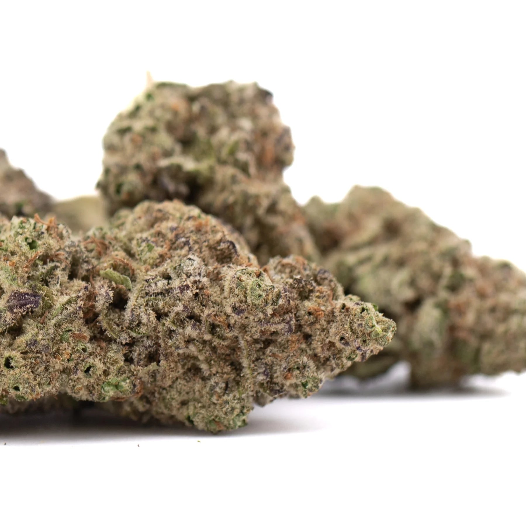 Green and brown greenhouse thca flower buds with dense frosty texture showcasing kush genetics and substantial potency