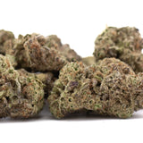 Green and brown gas thca flower with frosty texture showing authentic og kush and substantial potency gas profile