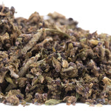A pile of dried green and brown glue full-term cbd trim hemp flower trim buds with textured appearance
