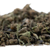A pile of dried green and brown chemdawg x gsc full-term thca trim with pungent garlic aroma for wholesale use