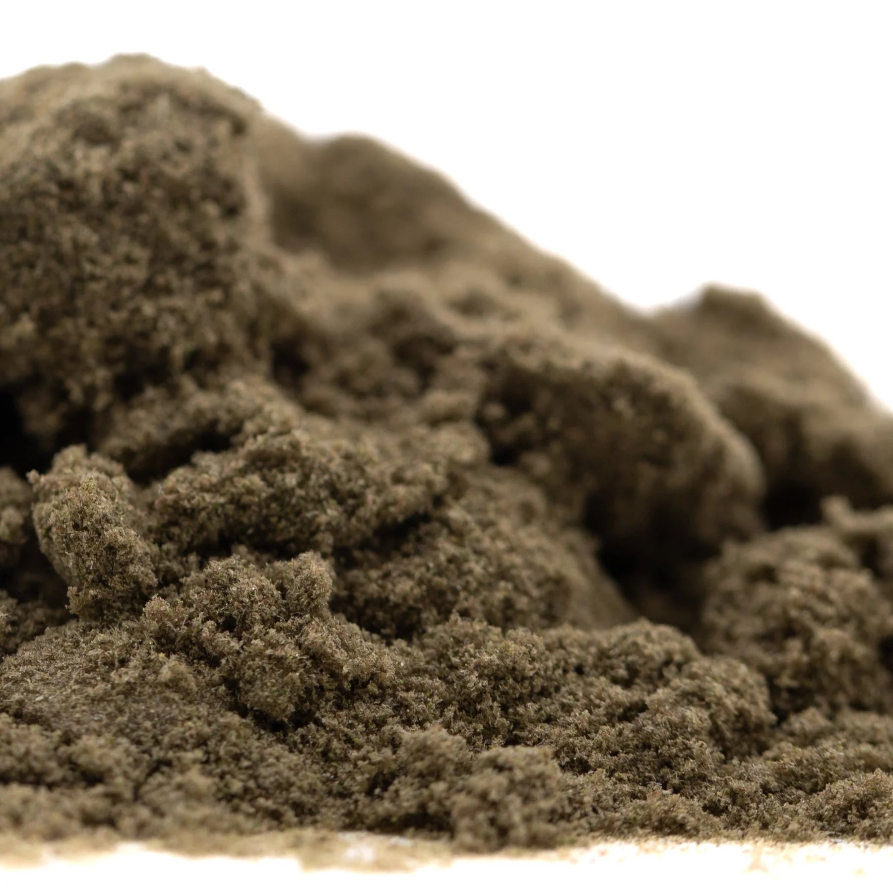 A mound of fine dark gray thca kief with a textured granular surface for top-shelf indoor garlic cookies cult use