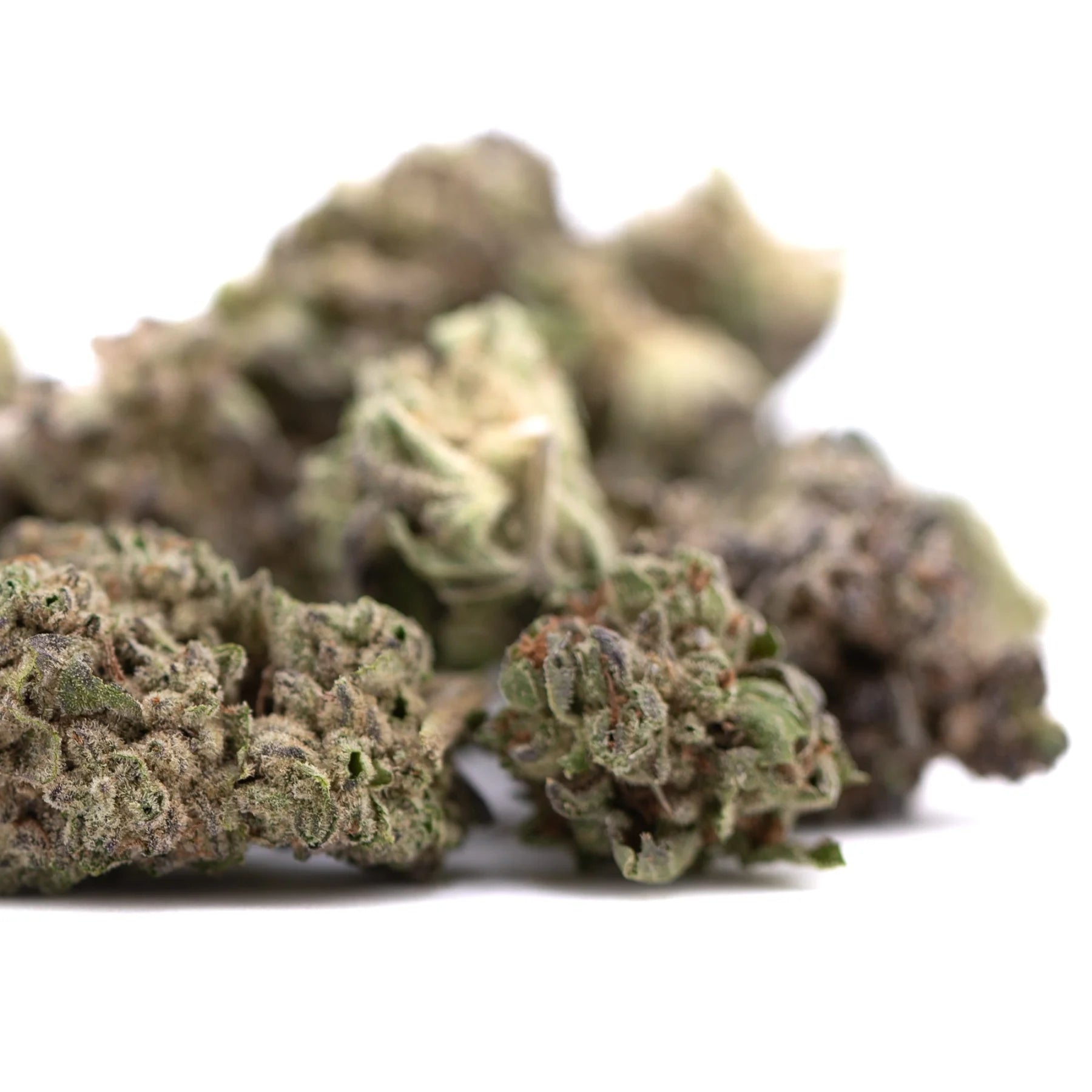 A pile of dried guava tartz thca hemp flower buds with dense green and brown hues from tropical genetics wholesale