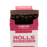 A box of harlequin cbd cigarettes with black hemp flower rolls in white and pink packaging from hemp flower co