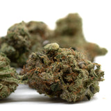 Dried cannabis buds with trichomes and orange hairs from Hash Man Indoor THCa Flower