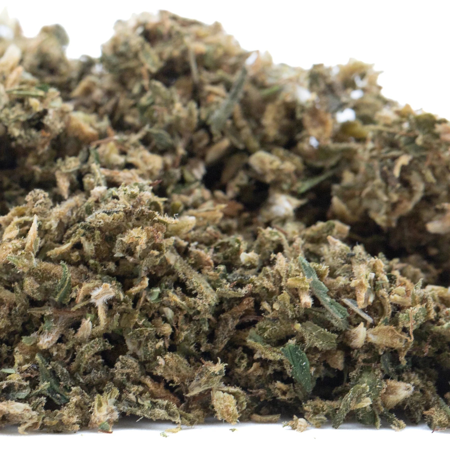 A dense textured pile of green and brown hempress cbd hemp flower buds showcasing cannabinoid potency for trim wholesale