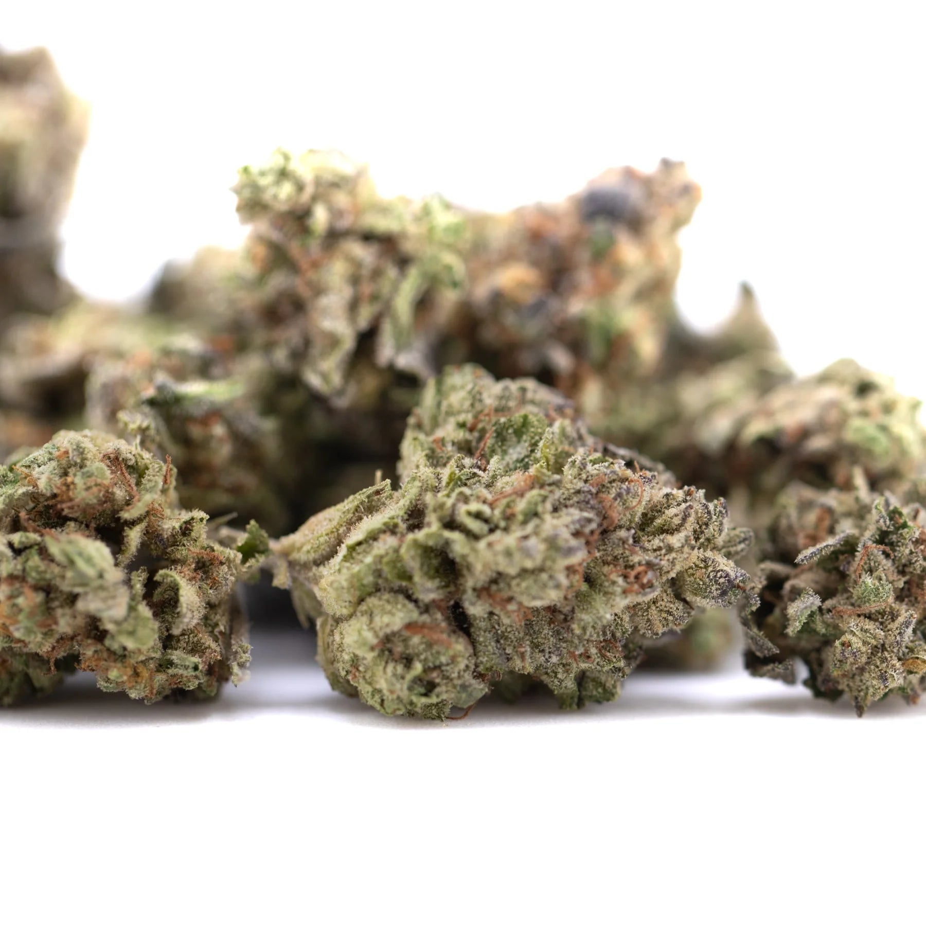 A cluster of dense green jealousy thca hemp flower greenhouse smalls with frosty trichomes and purple brown hints