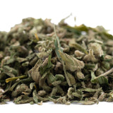 A pile of dried greenish-brown jelly donut full-term thca trim with trichomes and stems for deeply relaxing use