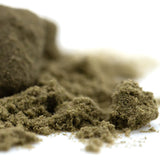 A mound of coarse earthy brown jelly donut kief with granular texture from louis xiii genetics hemp flower